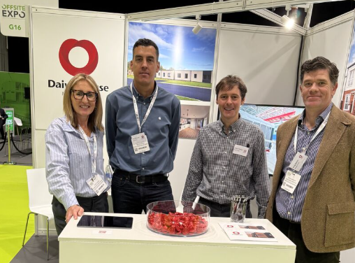 UK team of Daiwa House Modular Europe standing next to a table at the Offsite Expo in Coventry the largest exhibition for modular construction